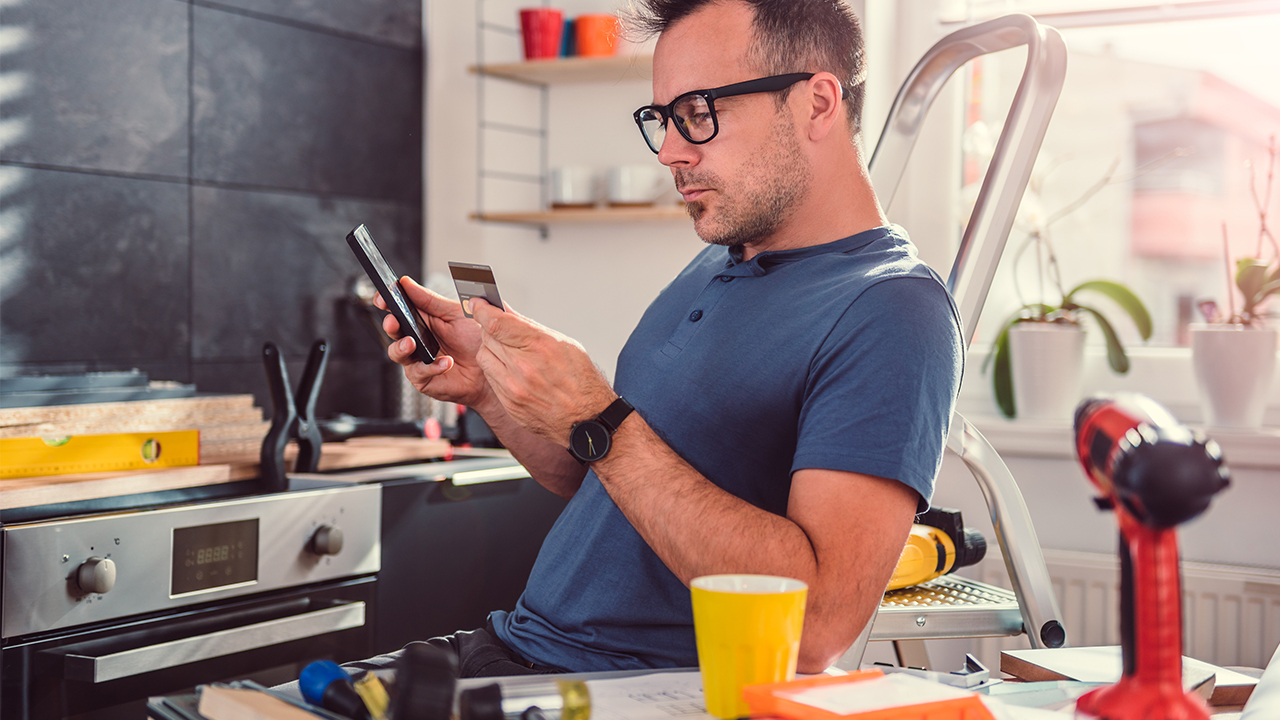 man uses credit card for home improvement purchase