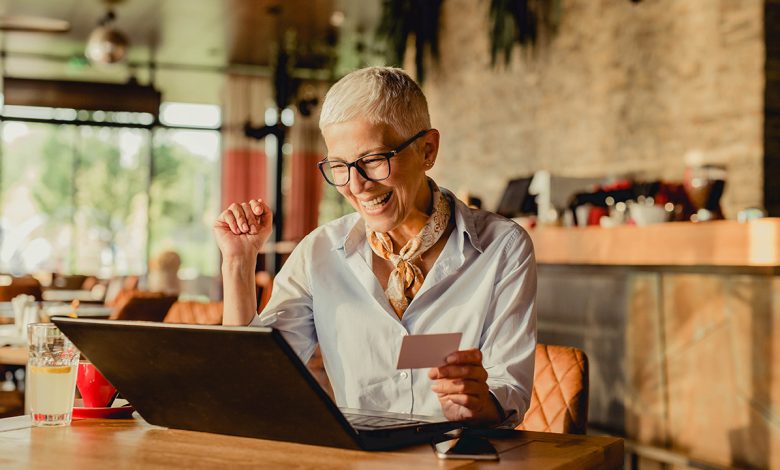 woman is excited to earn cash back with a credit card