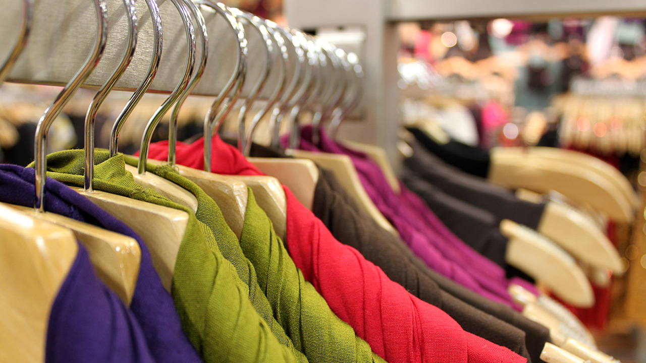 clothing hangs on a rack in a store