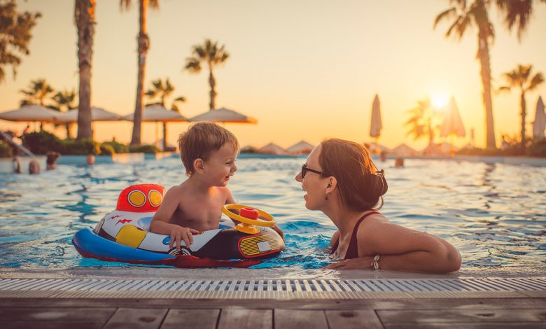 a mother and son relax by the pool