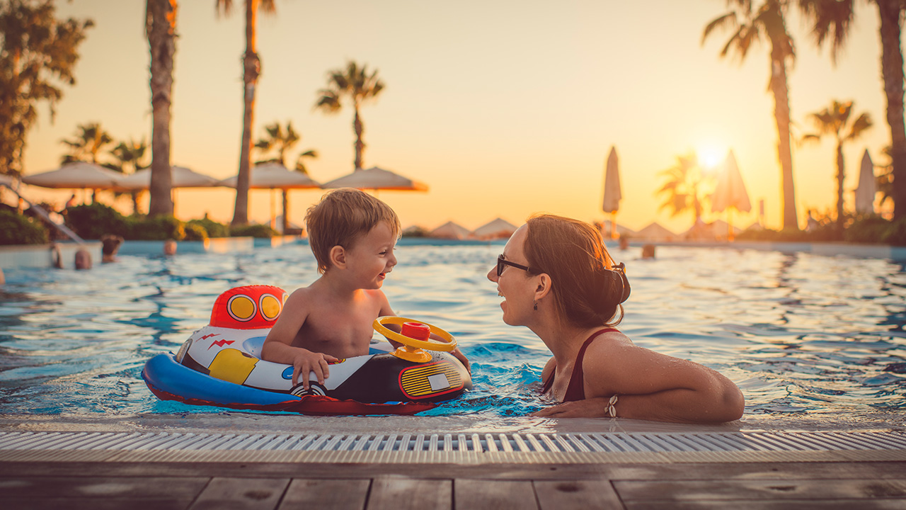 a mother and son relax by the pool