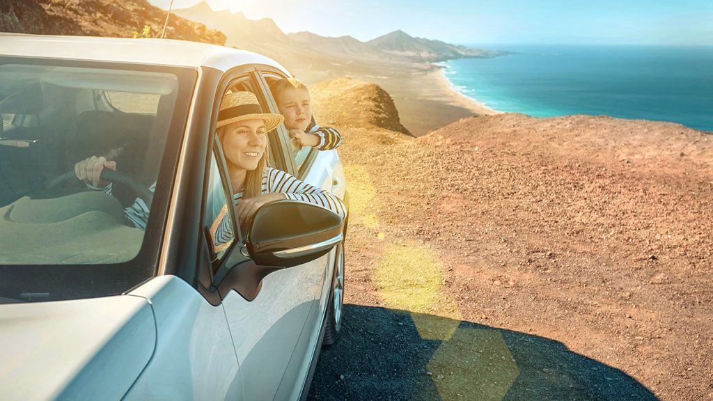 A family drives along the coast