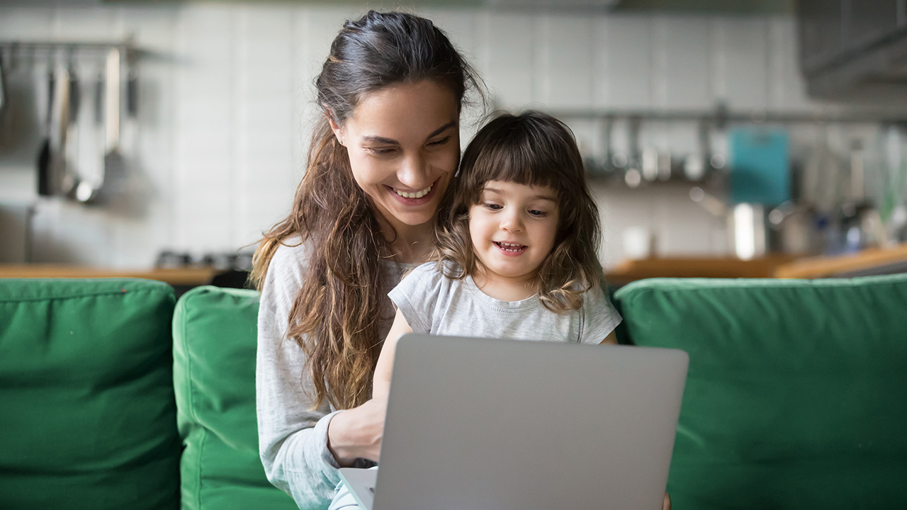 a mother and daughter use a laptop