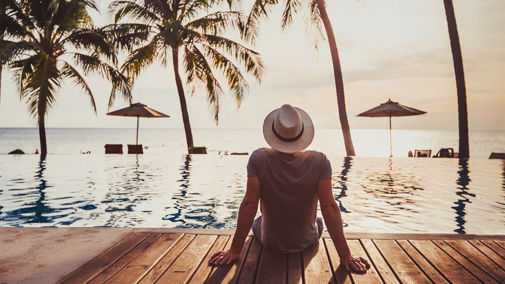 a man surveys a tropical location