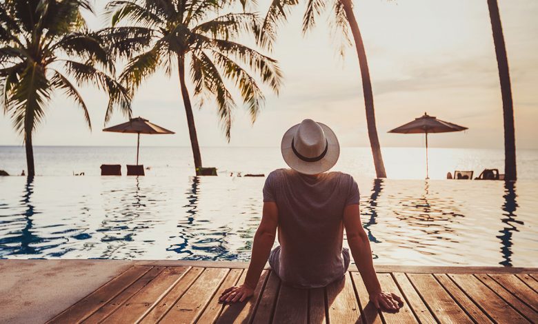 a man surveys a tropical location