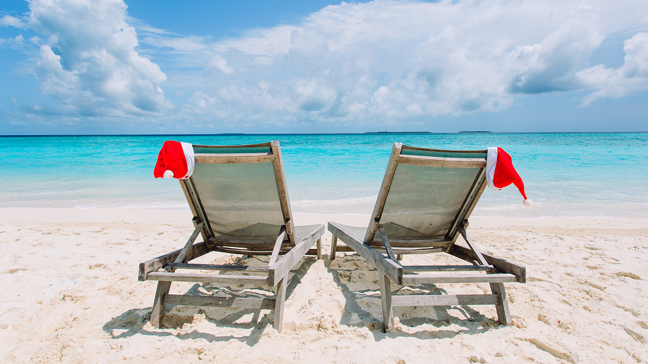 santa claus hats rest on beach chairs