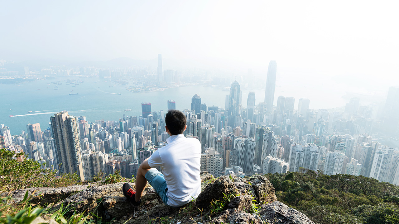 traveler looks at an asian cityscape