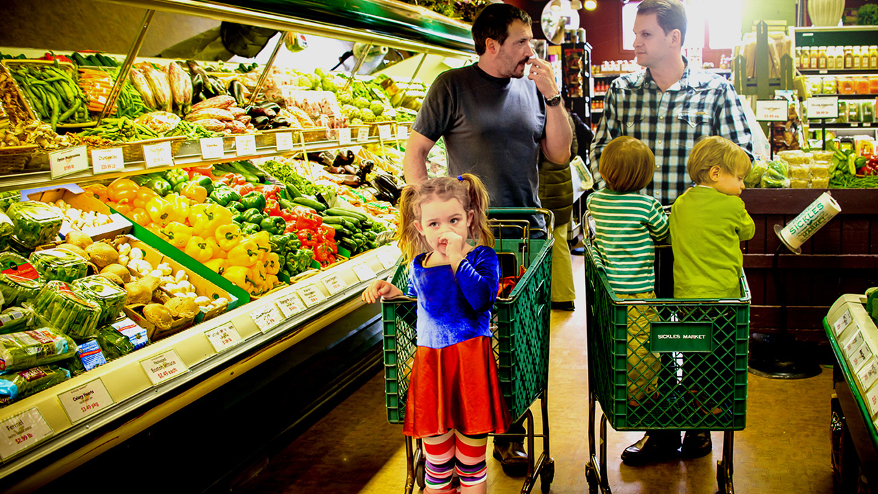 families at supermarket produce section