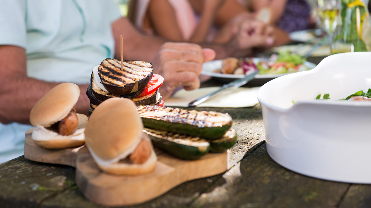 a family sits down to a meal outdoors