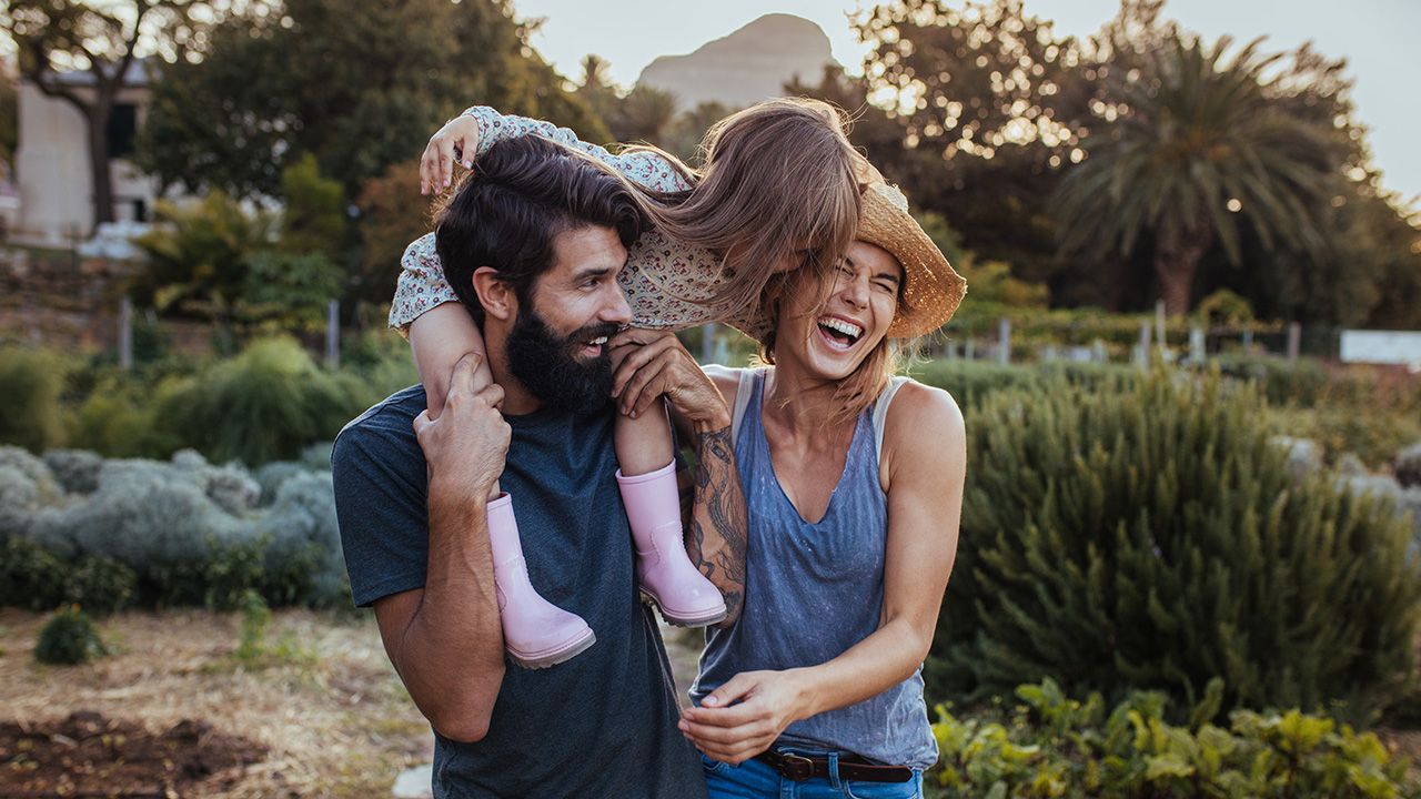 A happy family is walking and laughing outdoors