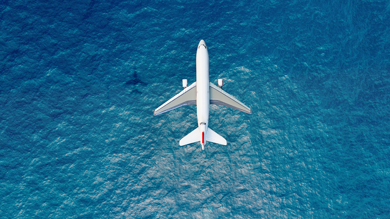 an airplane speeds across the sea