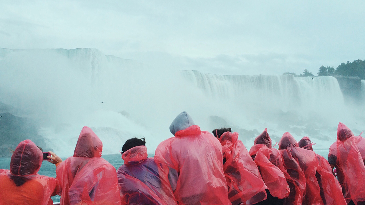 people gather at waterfall