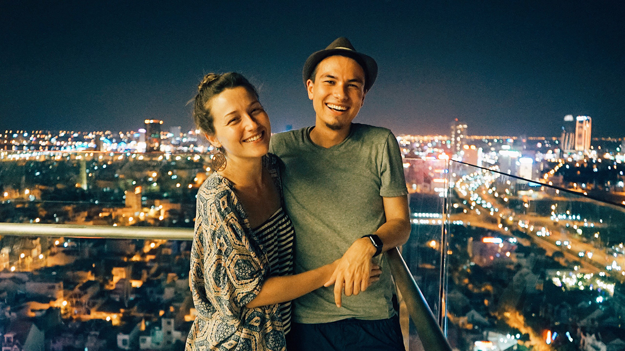 a laughing couple poses for a photo