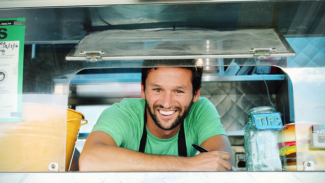 food truck worker smiles at customer