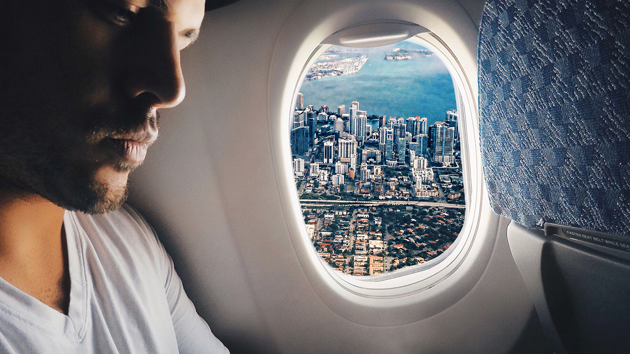 traveler sits near a window seat