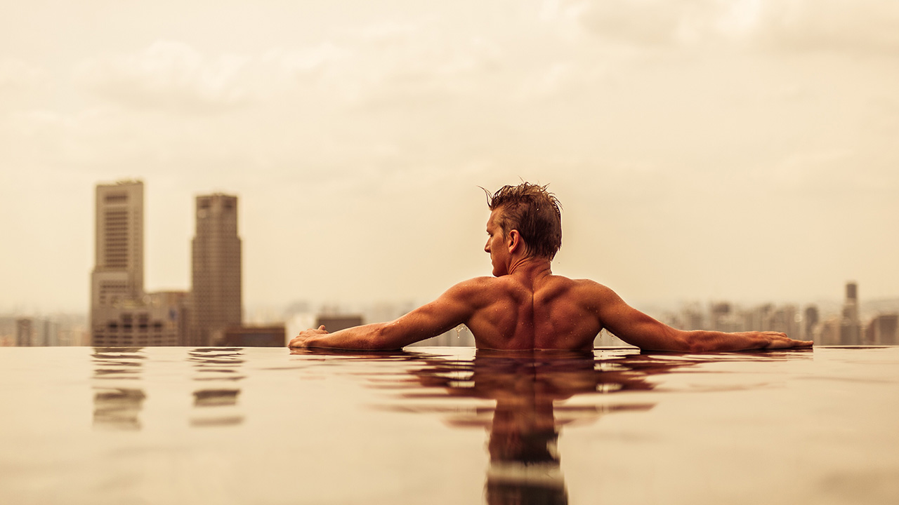 man swims in a pool