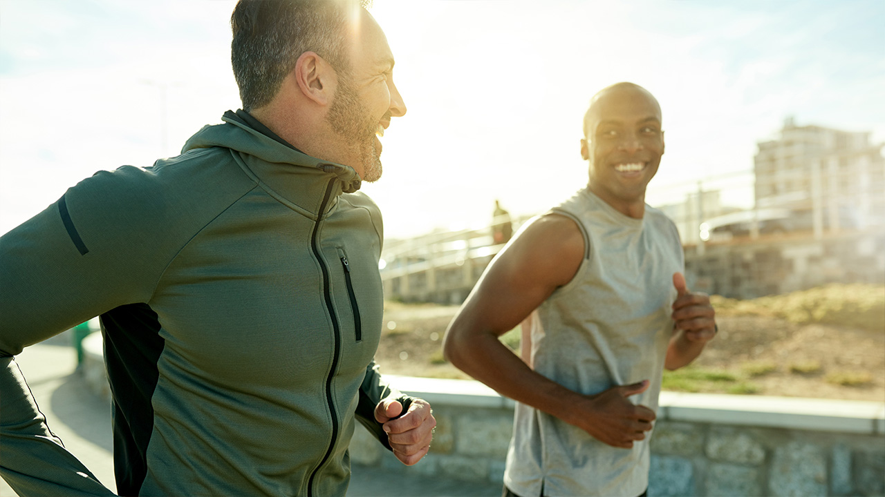 two men run outdoors