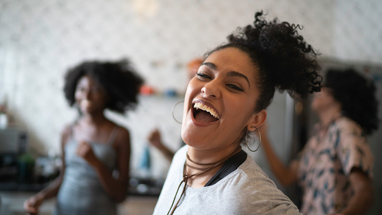 A happy woman is laughing at the camera