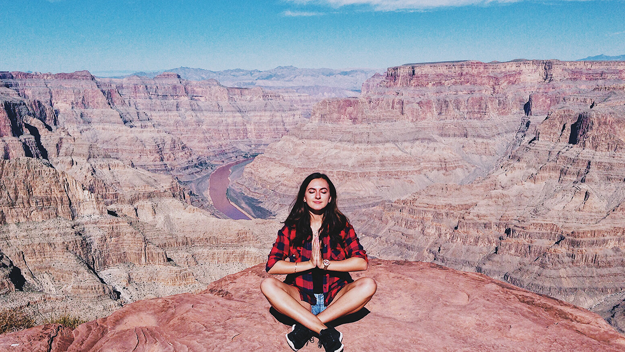 woman meditates outdoors