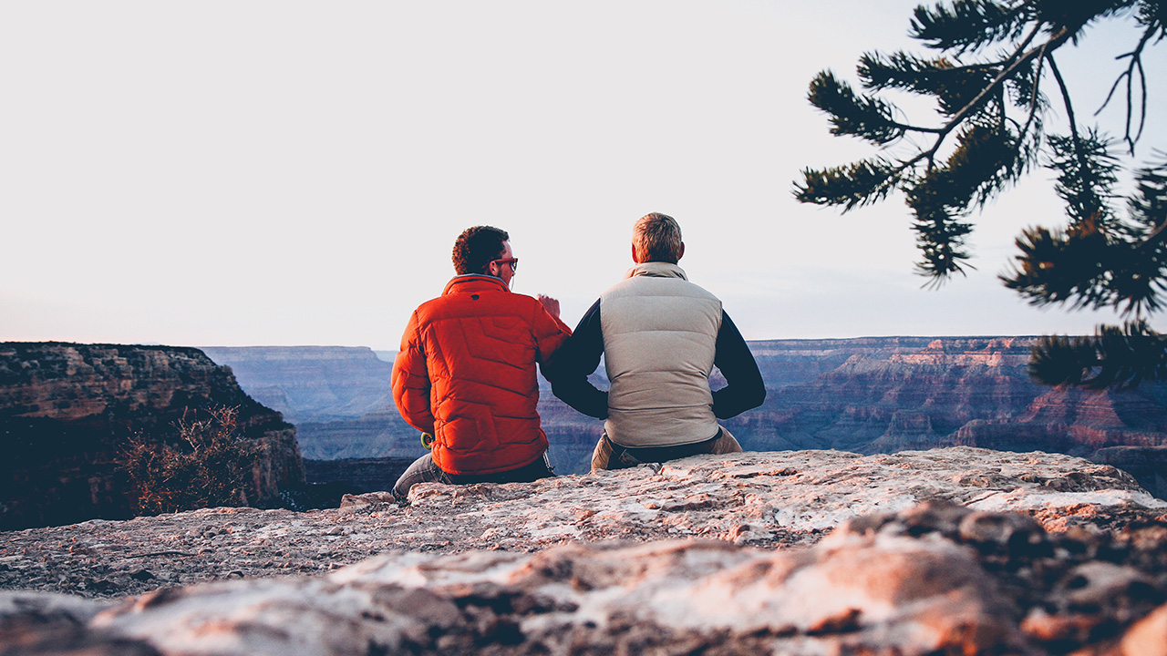 two men look at a scenic view