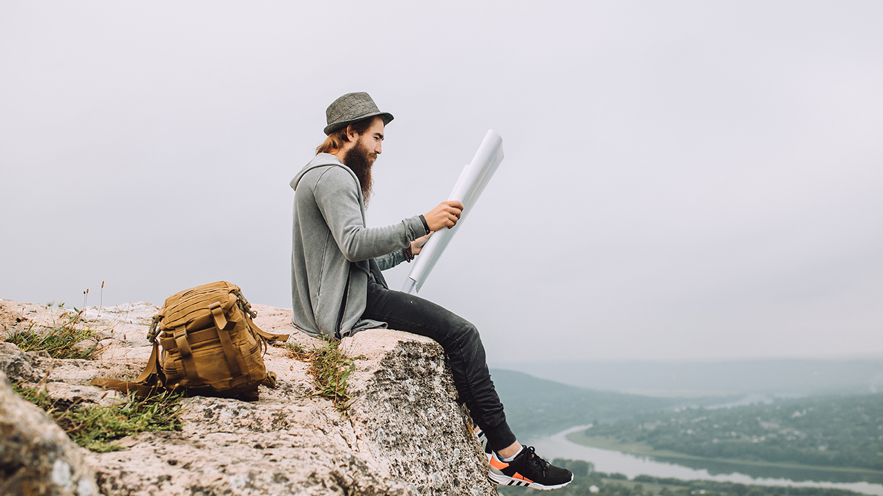 man reads from an overlook