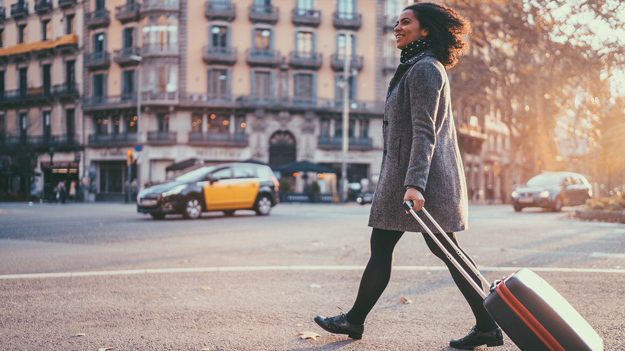 traveler walks through an urban area