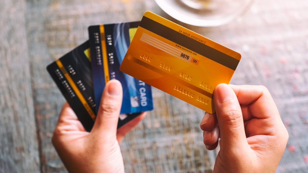 hands hold credit cards
