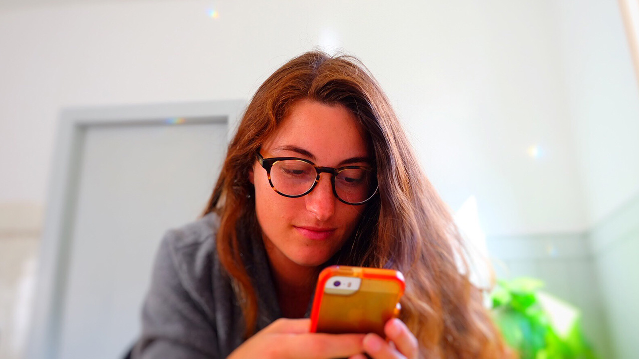 woman looks at phone