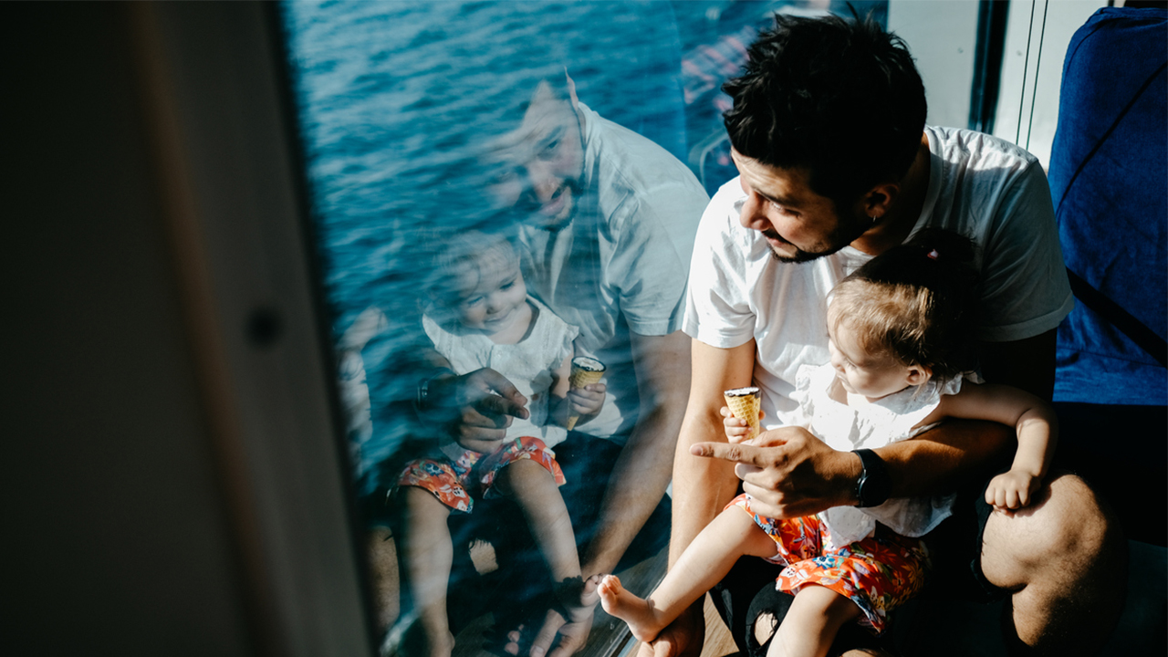girl-father-looking-out-cruise-ship-window