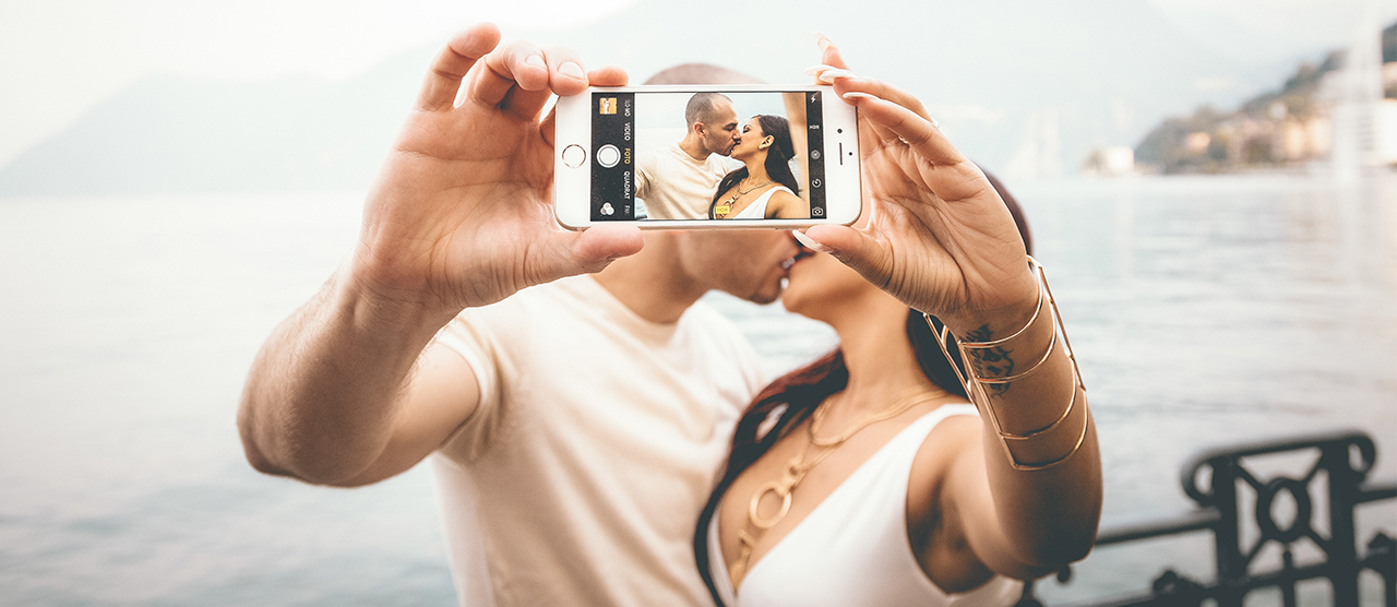 couple taking romantic selfie pics while kissing