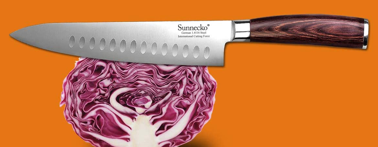 Sunnecko-Hollow-Edge-Chefs-Knife-on-orange-background