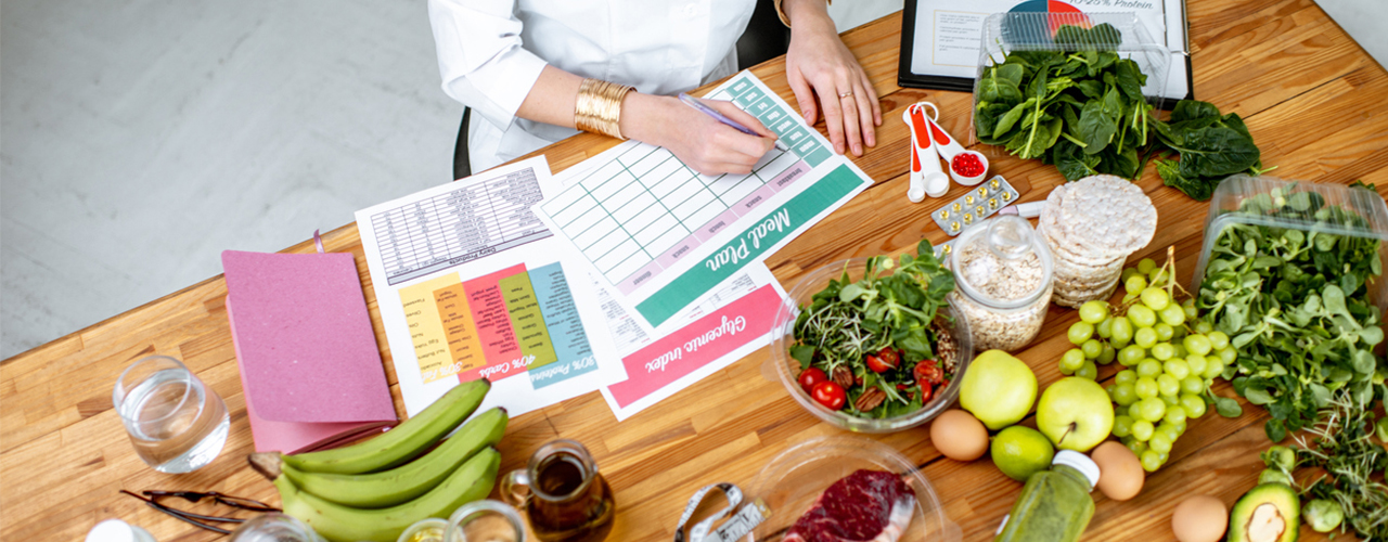 woman-making-diet-meal-plan-surrounded-by-healthy-food