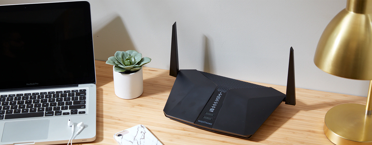 networking-wifi-router-next-to-laptop-on-desk