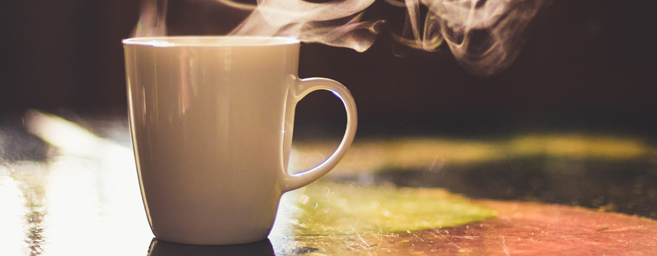 steaming-coffee-in-sunlight-on-table