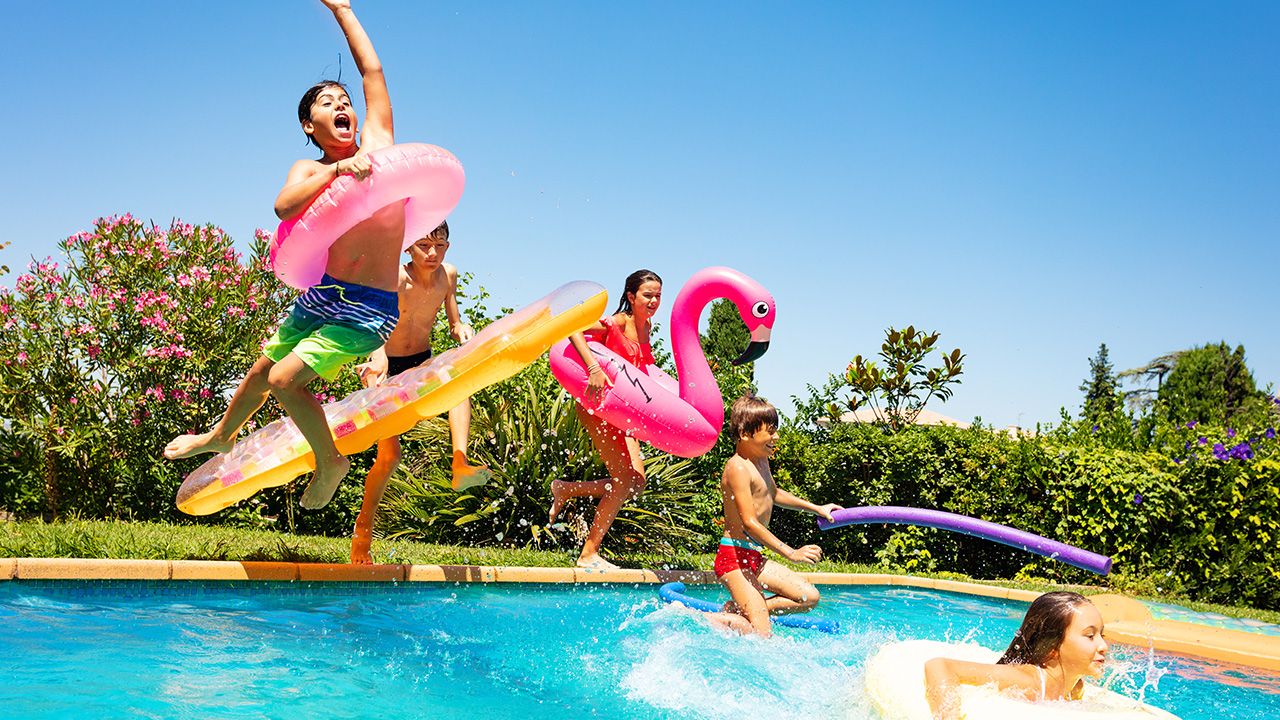 happy kids swim in a pool