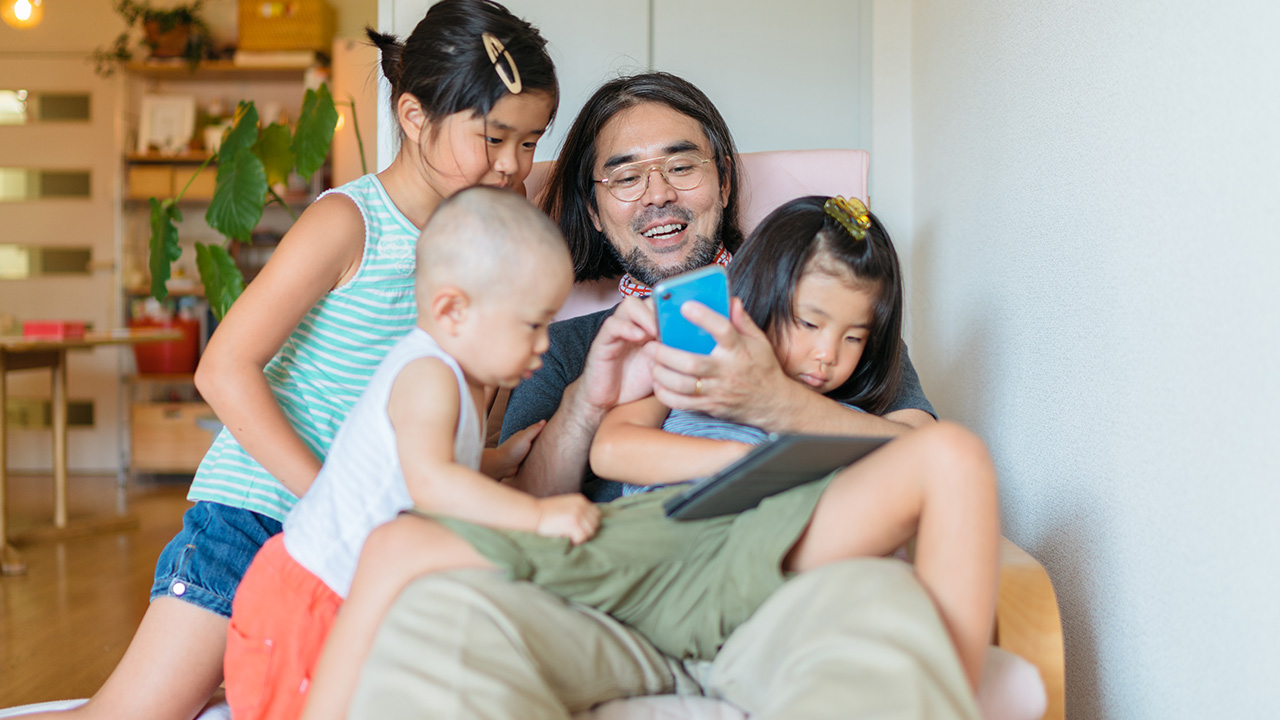 Children wrestle with father