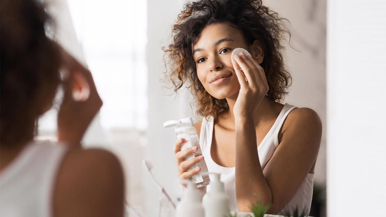 iStock-Prostock-Studio hero makeup cleaning Beautiful afro woman in bathroom stock photo