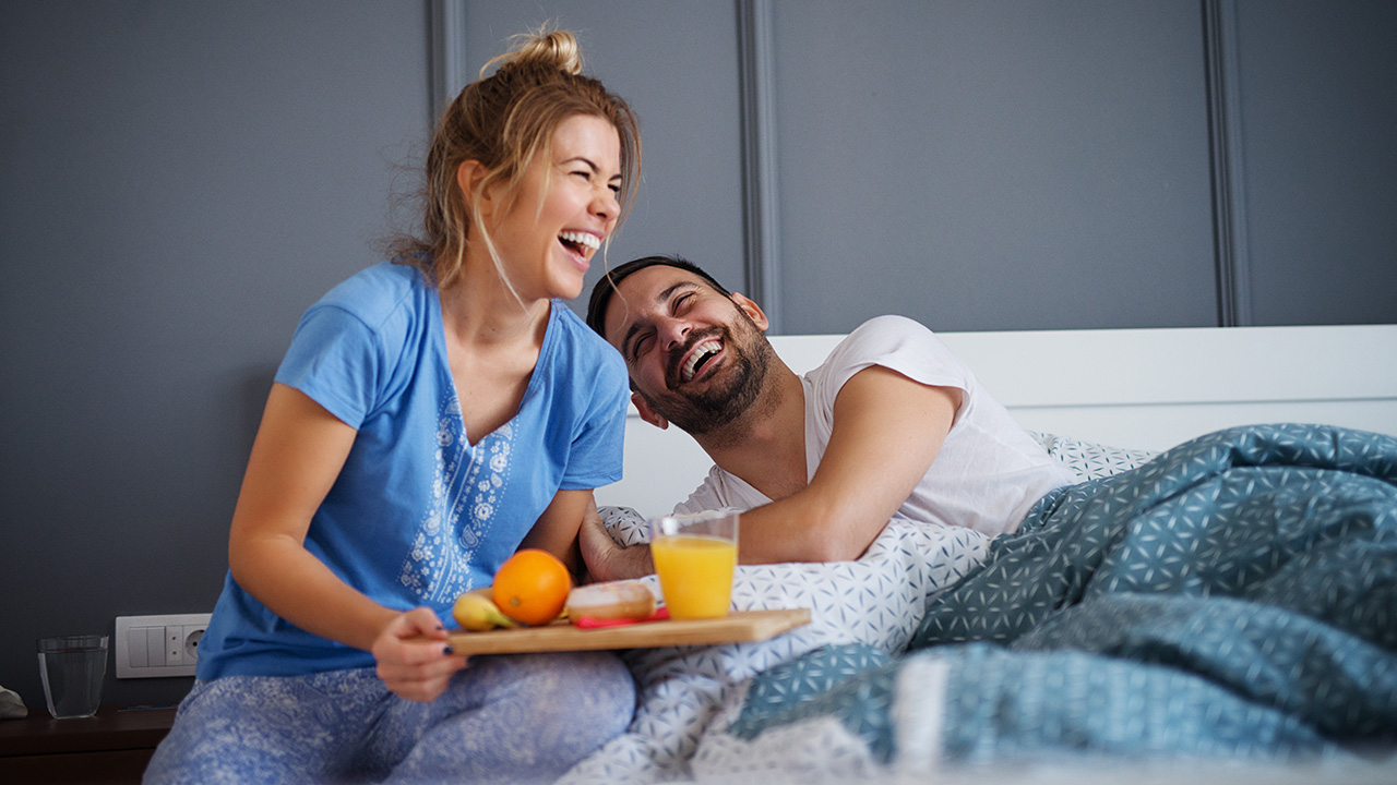 happy couple breakfast in bed