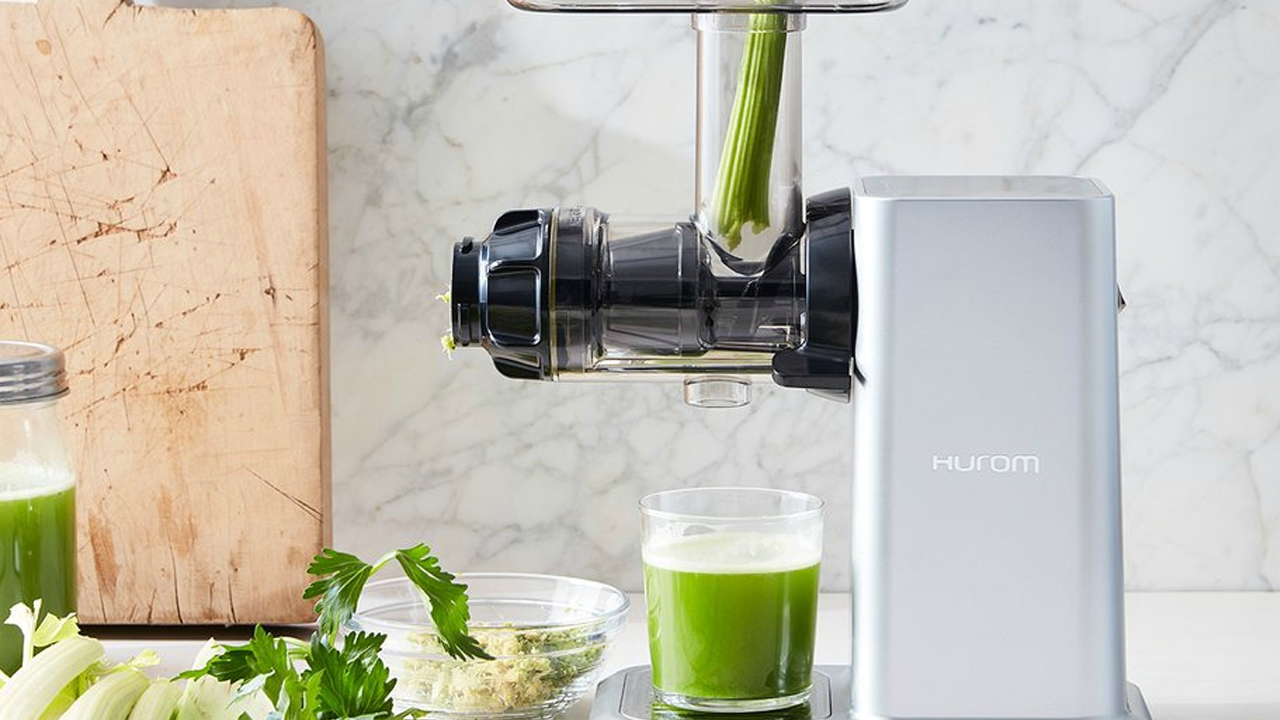 hurom-juicer-juicing-celery-into-glass
