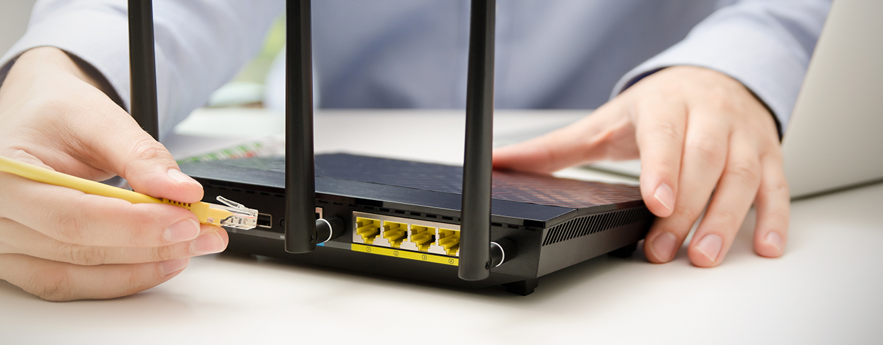 plugging in Ethernet cord to router