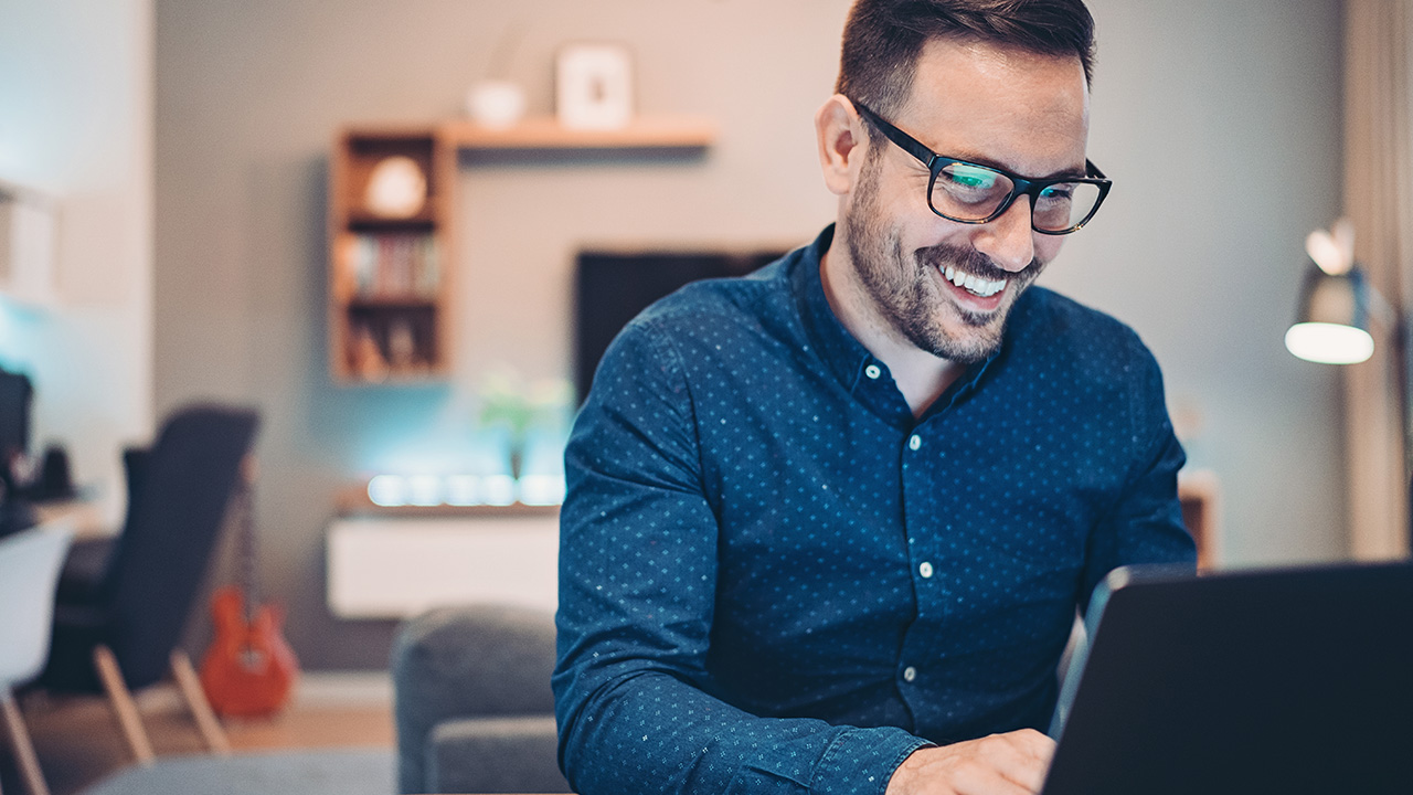 smiling man using the computer
