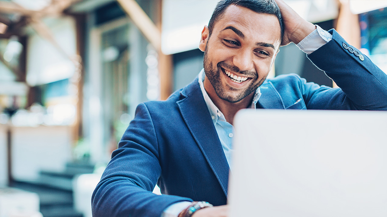 Happy man looks at screen