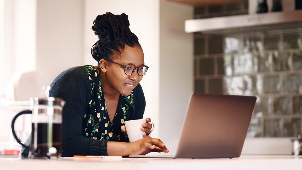 Looking at laptop in kitchen