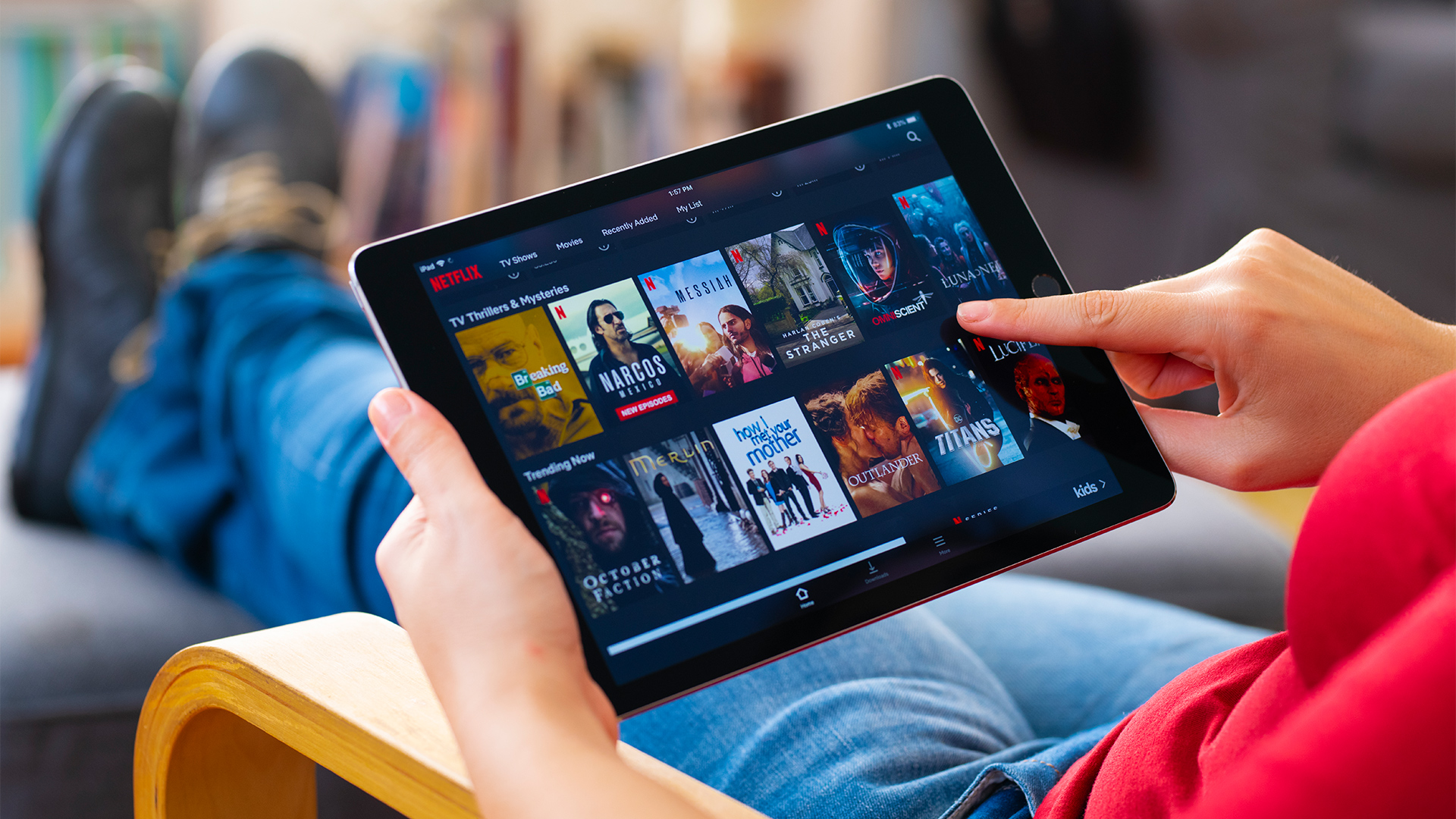 hero iStock-1208363215 hocus-focus tablet hand netflix home shoes