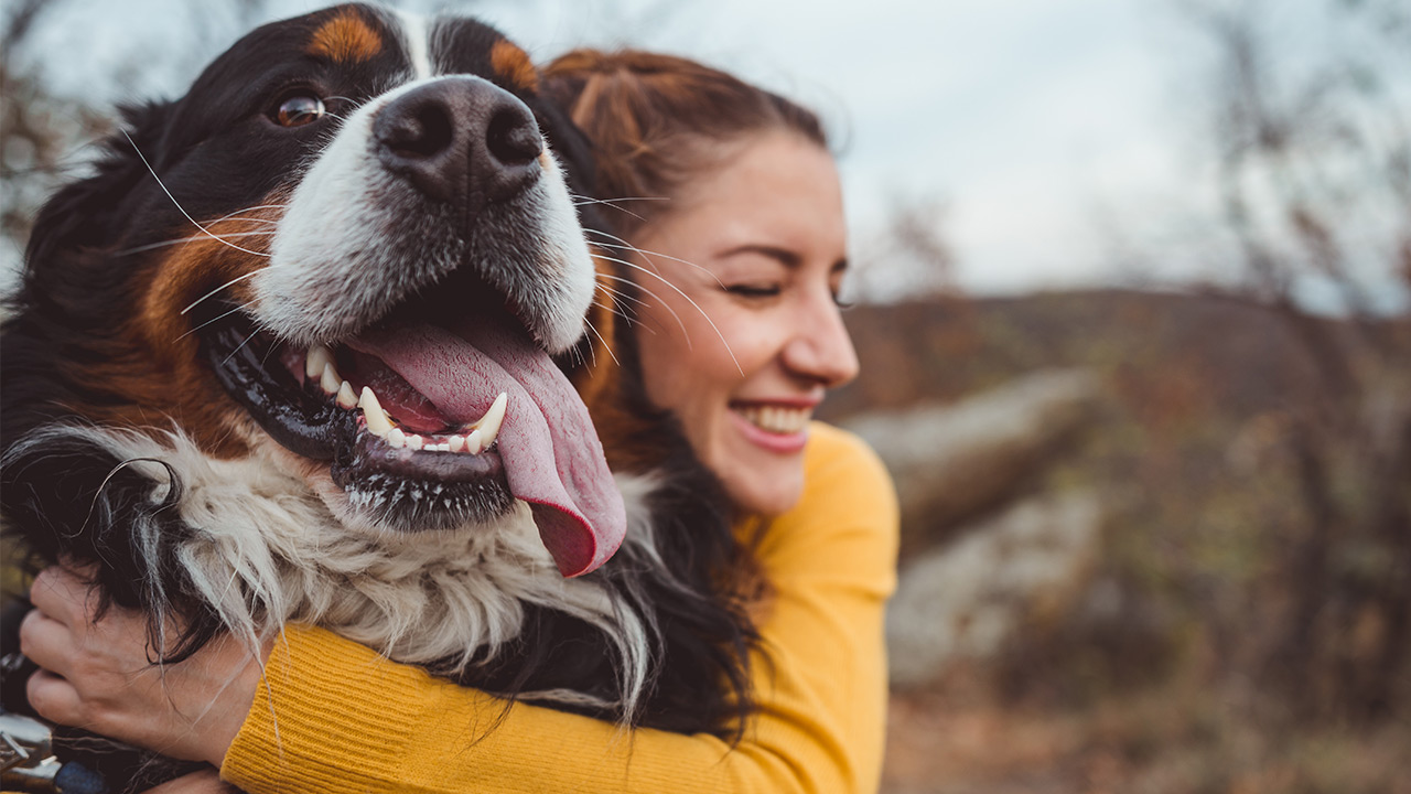 woman cuddles pup