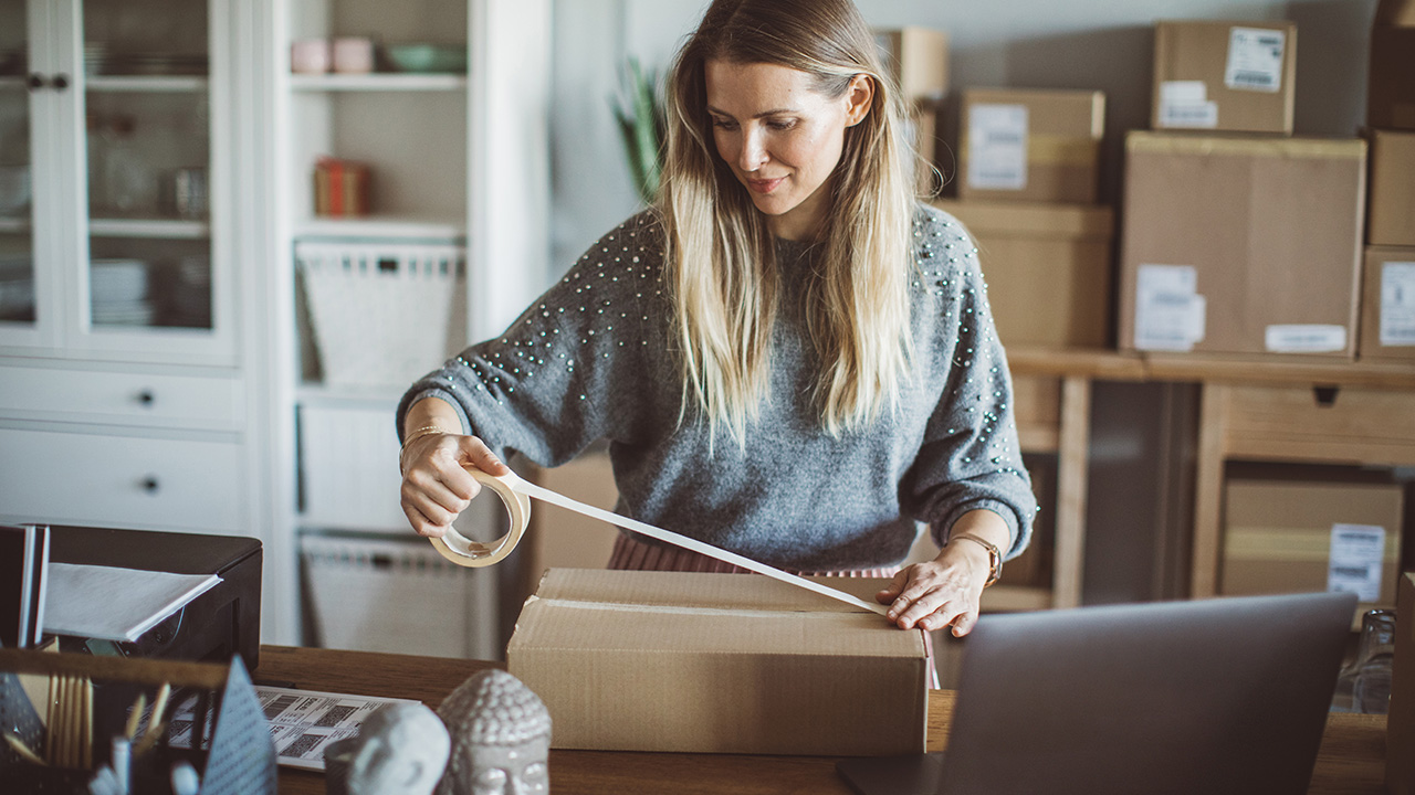 woman preparing cardboard boxes