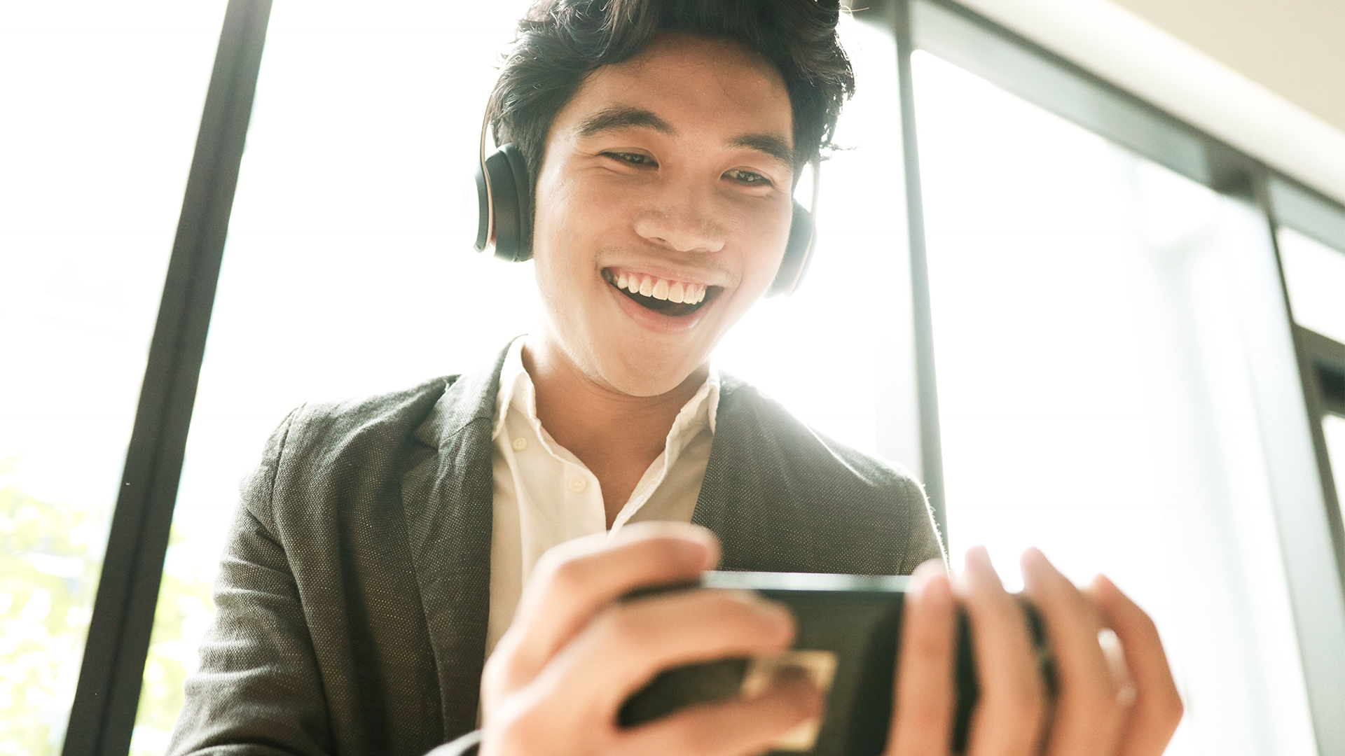 Young man is enjoying new mobile app hero