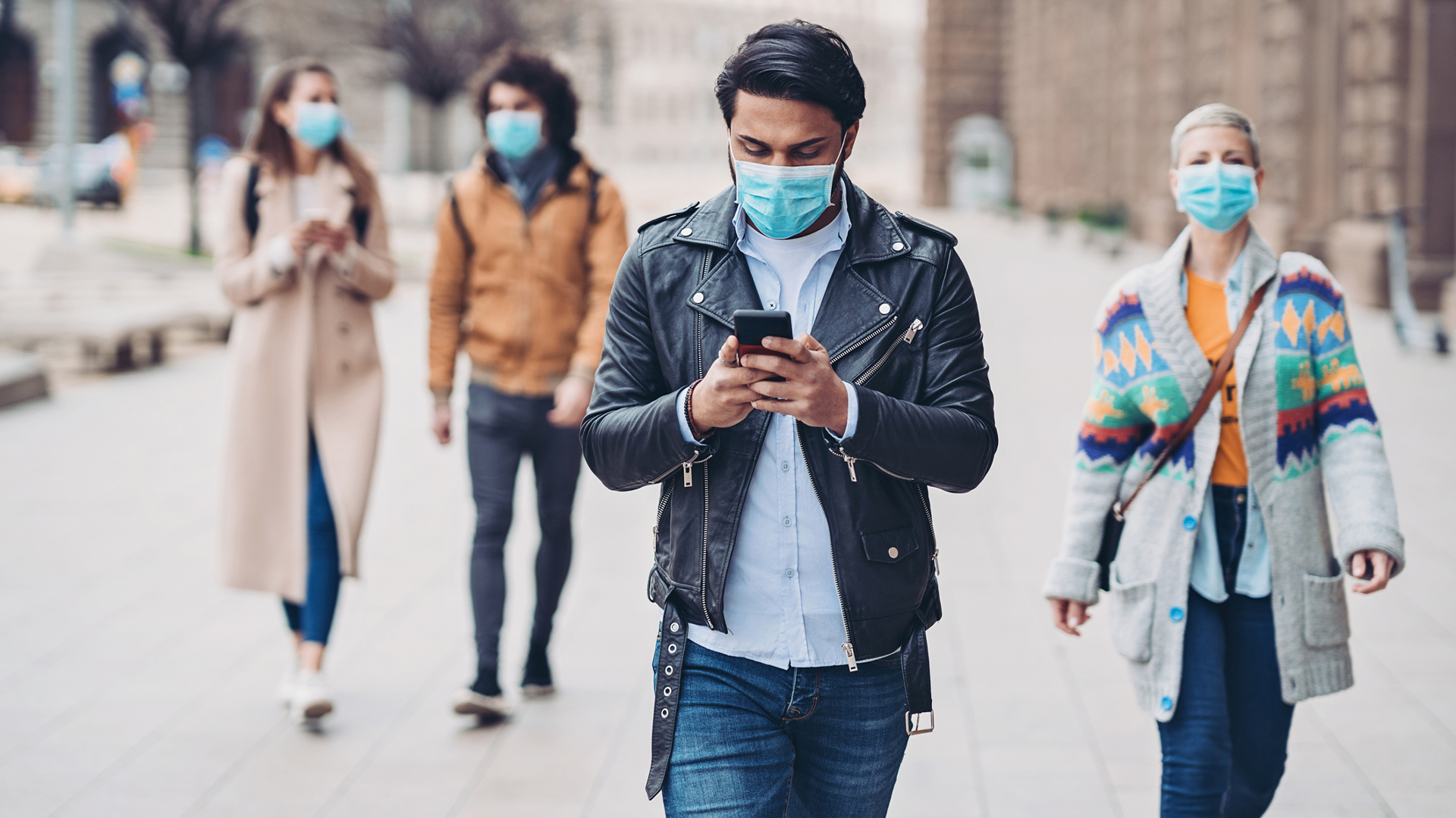 people walking on sidewalk with face masks