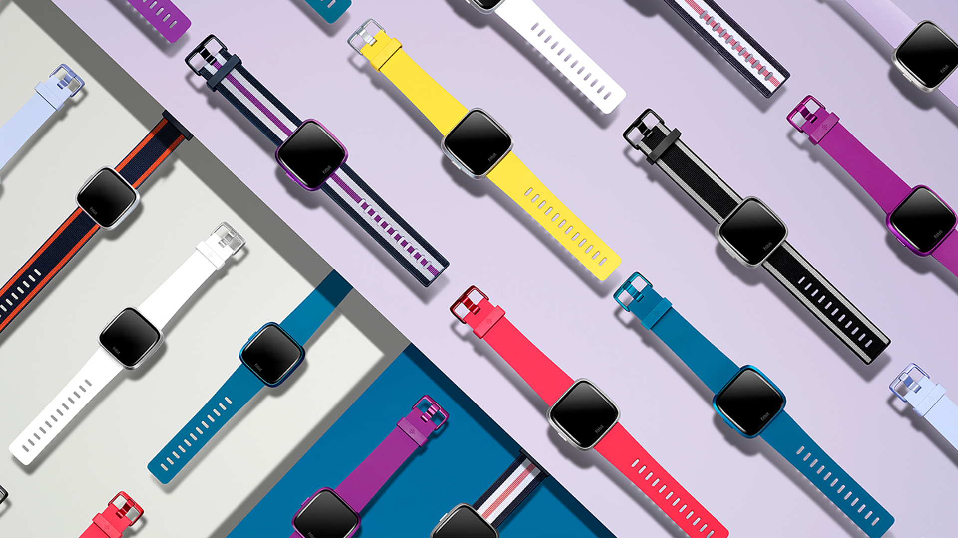 fitbit smart watches on colorful backgrounds