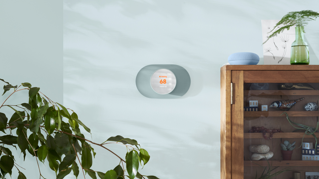 Nest Thermostat in Fog color on the wall